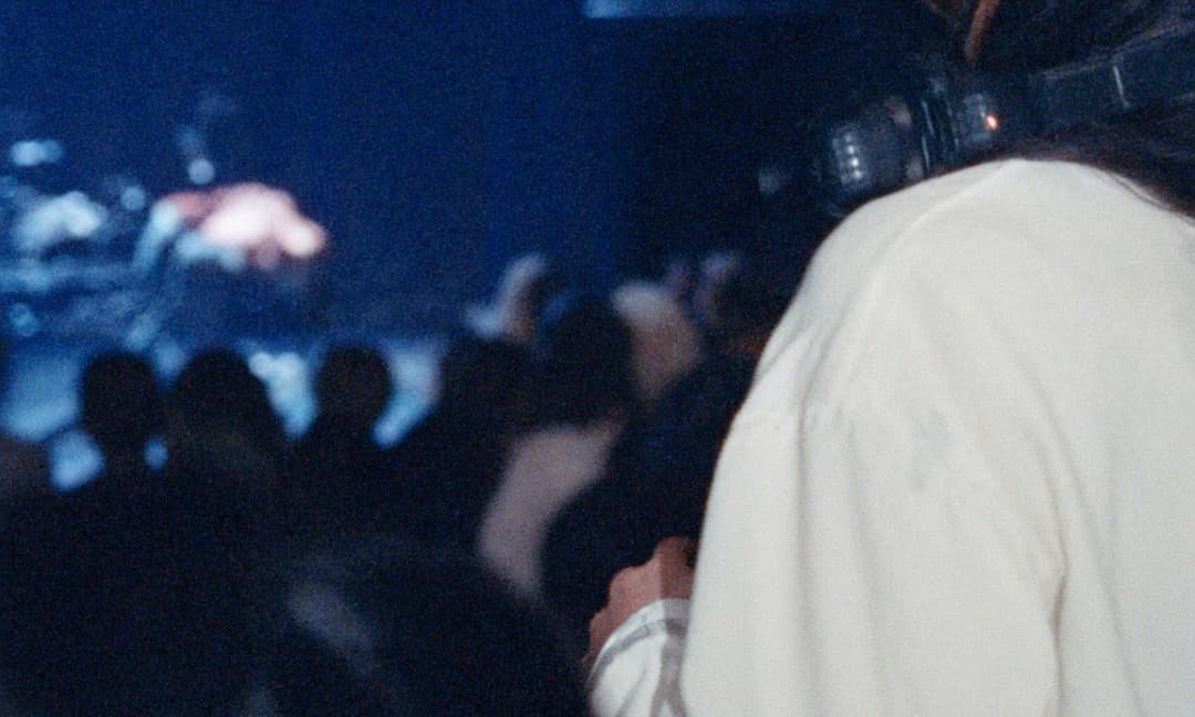 The front of a small, full room at a show
